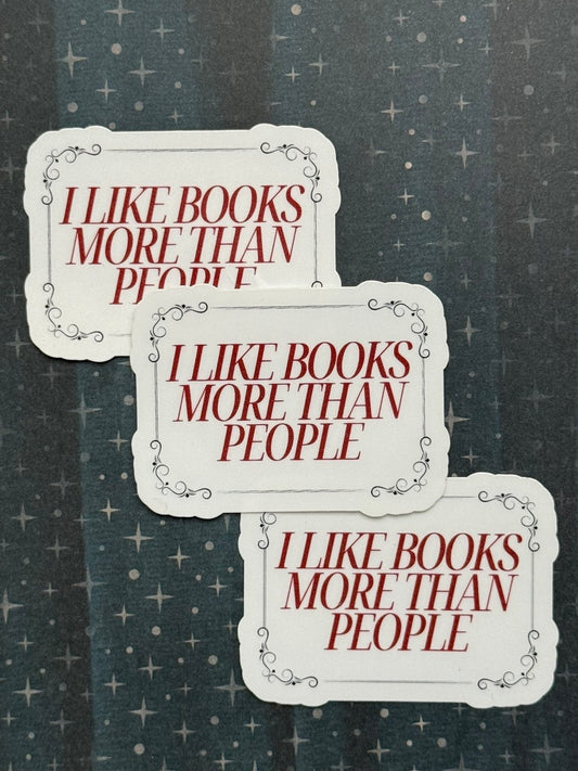 Three identical stickers with text 'I LIKE BOOKS MORE THAN PEOPLE' on a textured background.