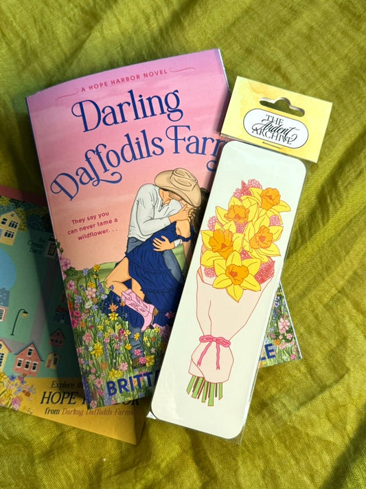 Book titled 'Darling Daffodils Farm' with a matching bookmark on a green fabric background