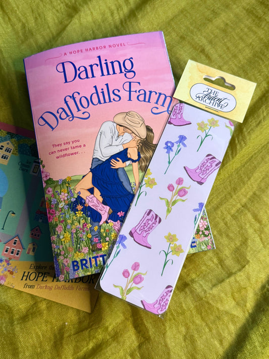Book titled 'Darling Daffodils Farm' with a matching bookmark on a green fabric background