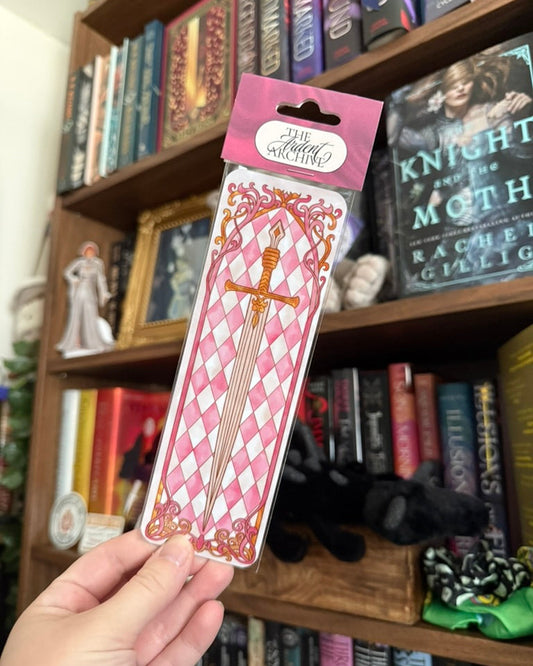 Sword Bookmark in plastic in front of a bookshelf