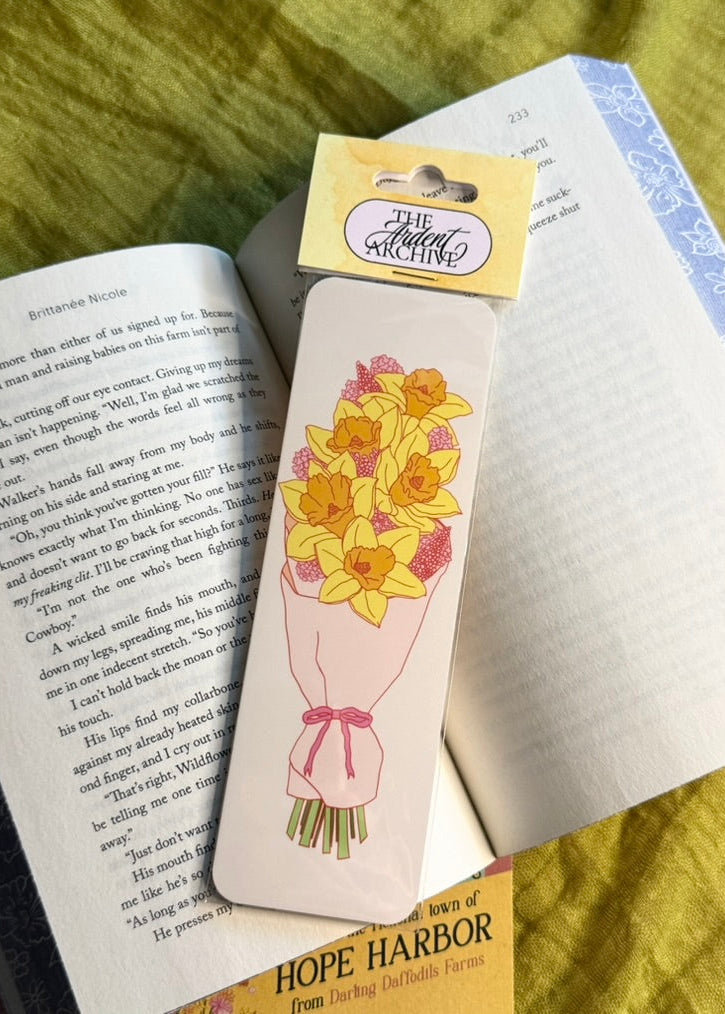 Floral-themed bookmark on an open book with a yellow label