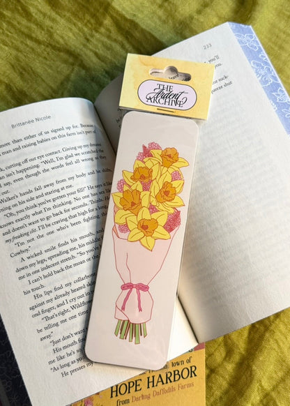 Floral-themed bookmark on an open book with a yellow label