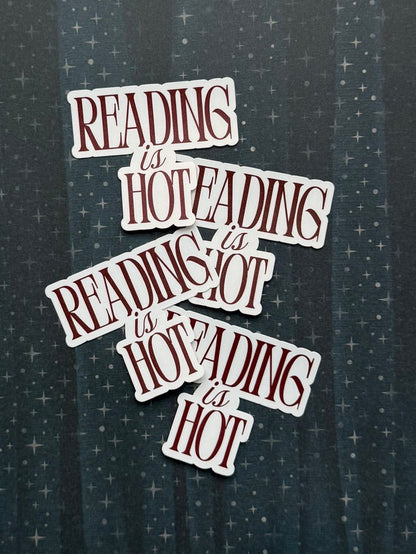 Stack of books with text 'Reading is hot' on a starry background