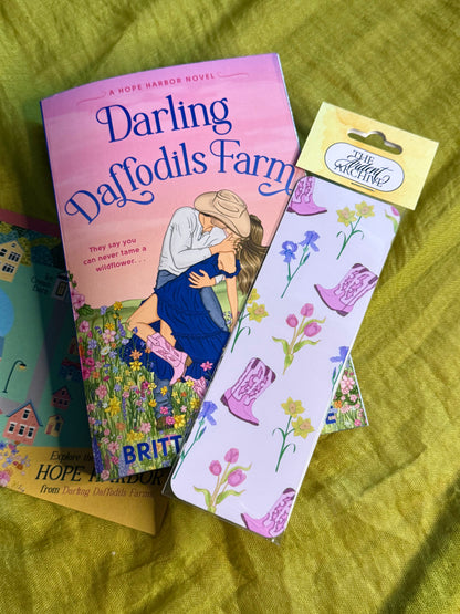 Book titled 'Darling Daffodils Farm' with a matching bookmark on a green fabric background