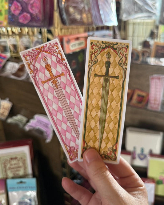 Hand holding two sword stickers
