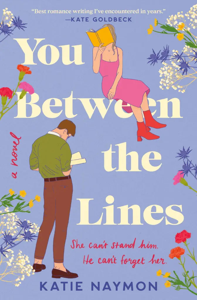 Book cover for 'You Between the Lines' by Katie Naymon, featuring an illustrated man reading and a woman in a pink dress reading a book against a dusty blue background with floral borders and cream title text.