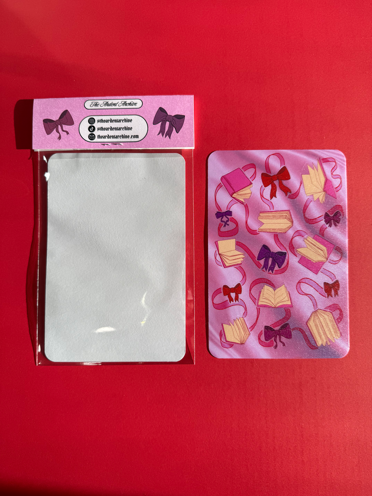 Sticker sheet of decorative ribbons and bows on a pink card with a red background.