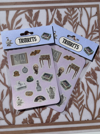 Two packages of 'Trinkets' stickers on a decorative background