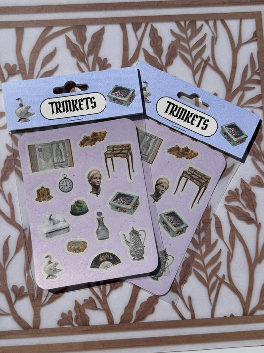 Two packages of 'Trinkets' stickers on a decorative background