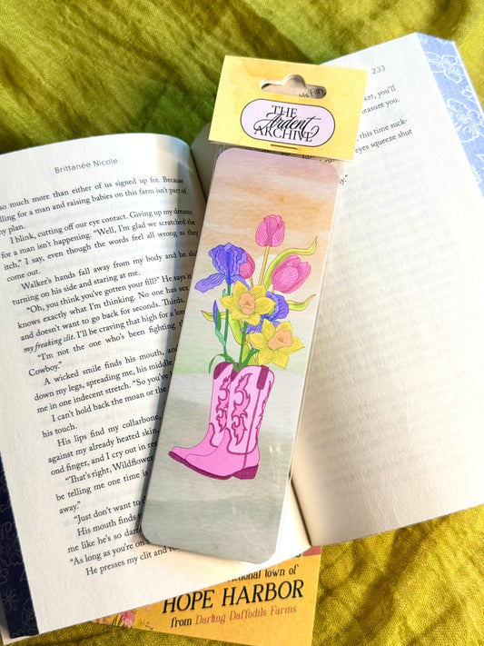 Bookmark with floral design and pink boot on a book