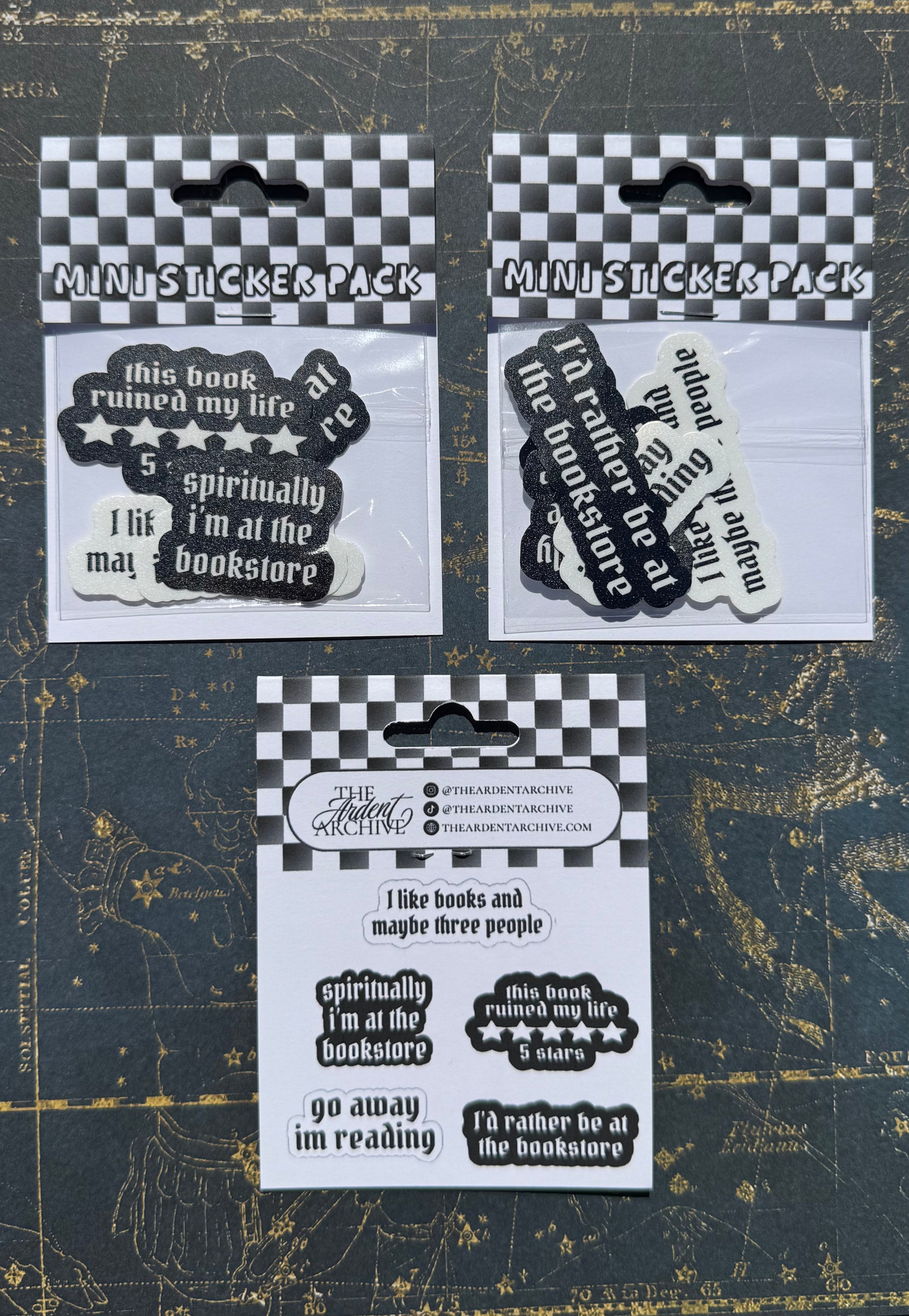 Three packs of stickers with humorous text on a dark background