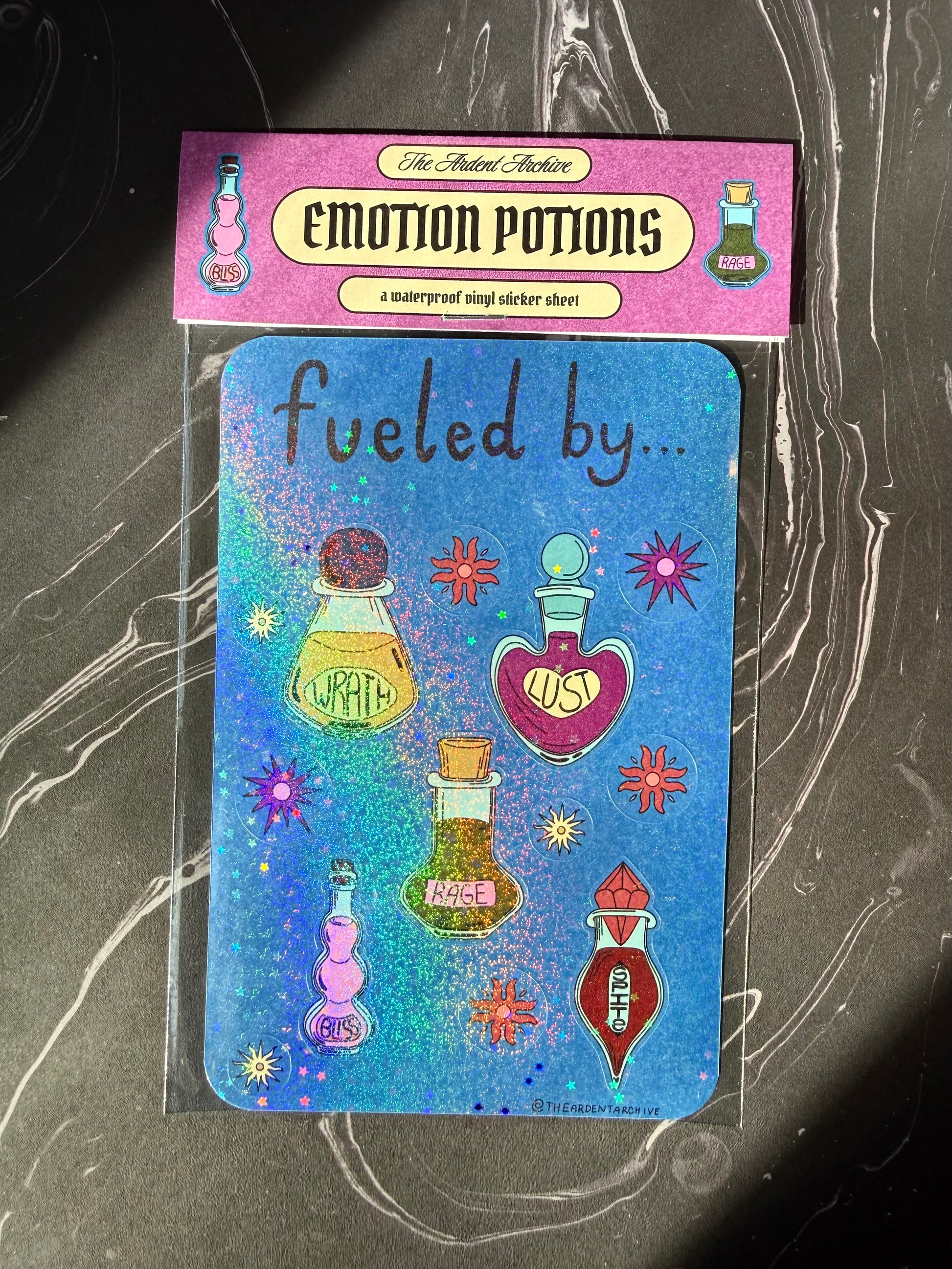 Blue holographic sticker sheet with potion bottles that say wrath, lust, rage, spite, and bliss in different colored potion bottles surrounded by flower illustrations with purple header card that says "the ardent archive" "emotion potions" and "waterproof vinyl sticker sheet" 