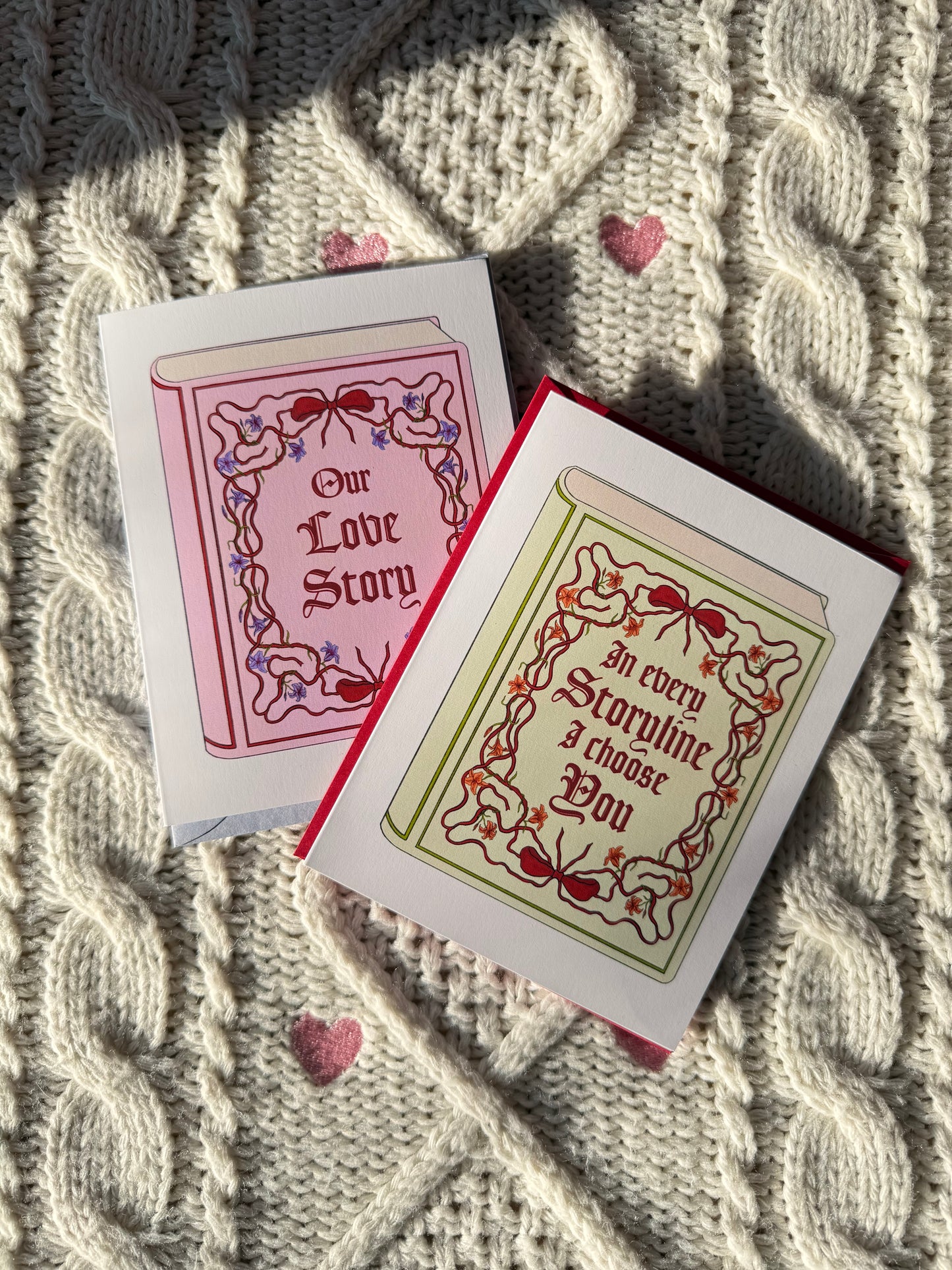 Two greeting cards with decorative designs and text on a textured fabric background