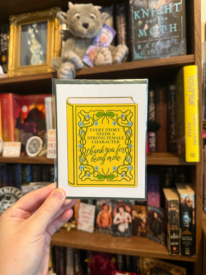 hand holding a yellow card in front of bookshelf
